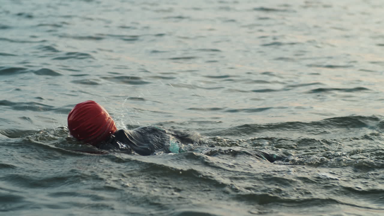 Woman Swimming in Lake while Training for Triathlon