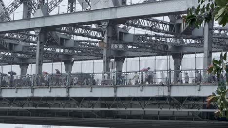 people walking on the iconic howrah bridge in kolkata