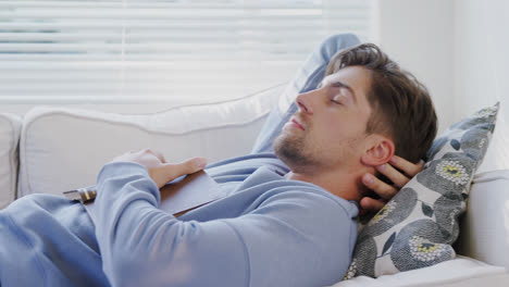 young man sleeping on sofa with his book 4k 4k