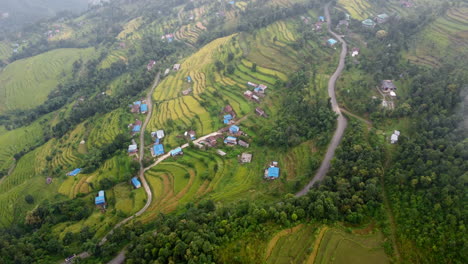 Neblige-Luftaufnahme-Von-Reisfeldern-Und-Bergen-In-Einem-Kleinen-Dorf-In-Nepal