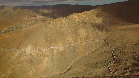 aerial view of the winding mountain road between two villages of fuerteventura.