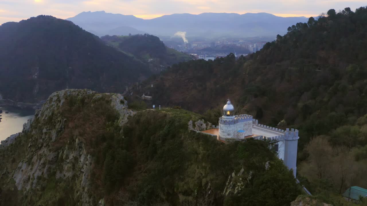 Ascending aerial shot capturing the prominent 'El Faro de la Plata' lighthouse