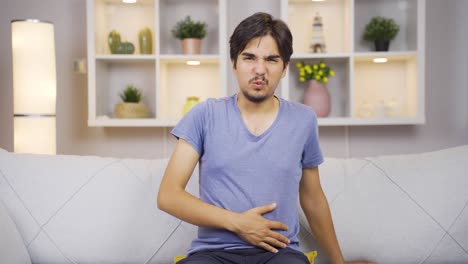 man experiencing stomachache.