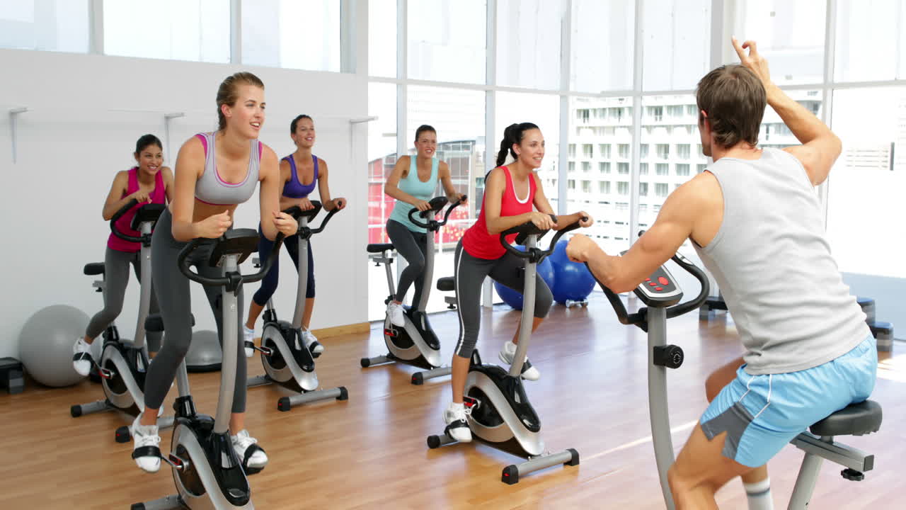 clase de spinning en un estudio de fitness dirigida por un instructor enérgico