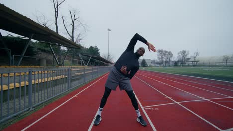 man stretching on a track