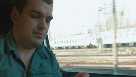 hombre tomando una píldora para el dolor de cabeza en el tren