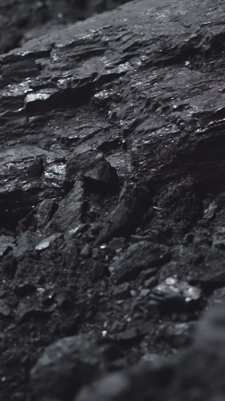 Textured charcoal pile in power generating station storage closeup. Fossil fuel extraction for industrial purposes. Burning rock deposits at plant