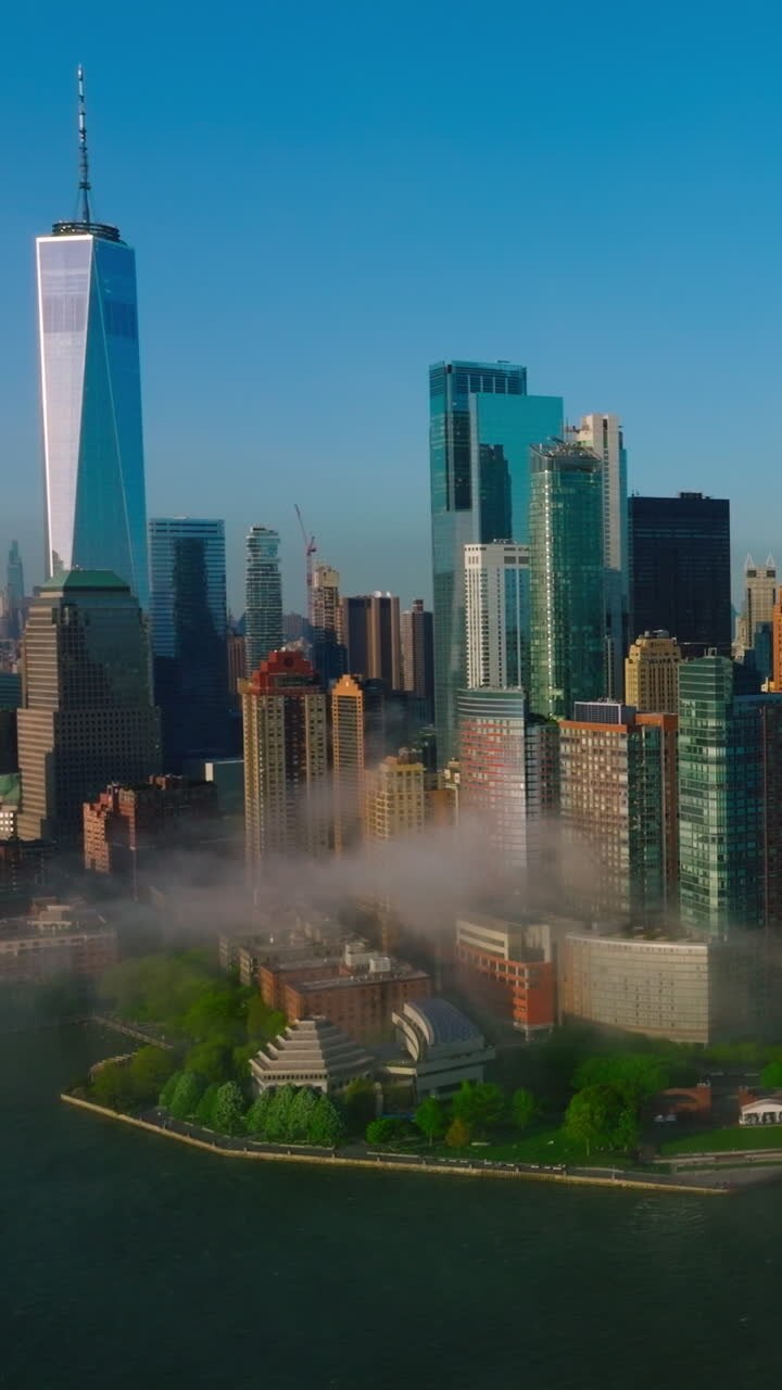 Lower Manhattan Financial District in the light of bright sun. New York city skyline at the backdrop of clear blue sky. Vertical video
