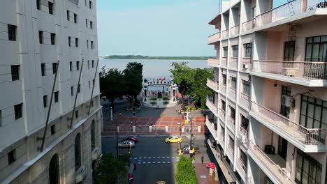 aerial view flying over avenue 9 de octubre and towards la rotonda monument in guayaquil, the main avenue in the city