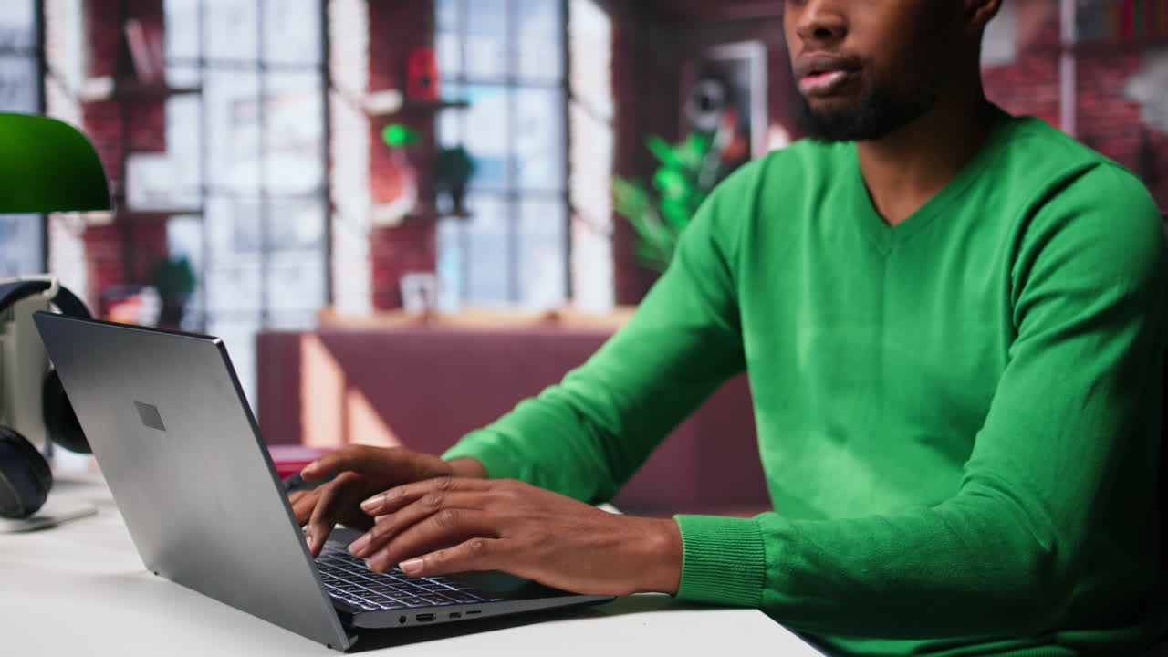 Vertical Video African american male freelancer at home focused on online research