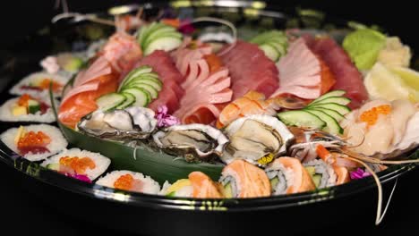 assorted sushi selection displayed on a rotating platter.