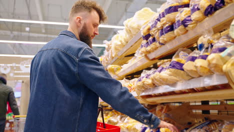 man shopping for bread in a grocery store