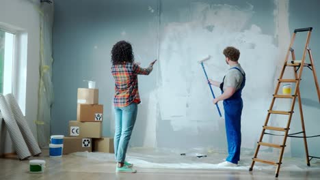 couple painting a room during home renovation