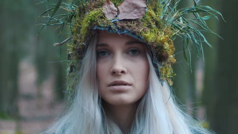 Beautiful-forest-girl-with-natural-grass-crown-look-up-into-camera