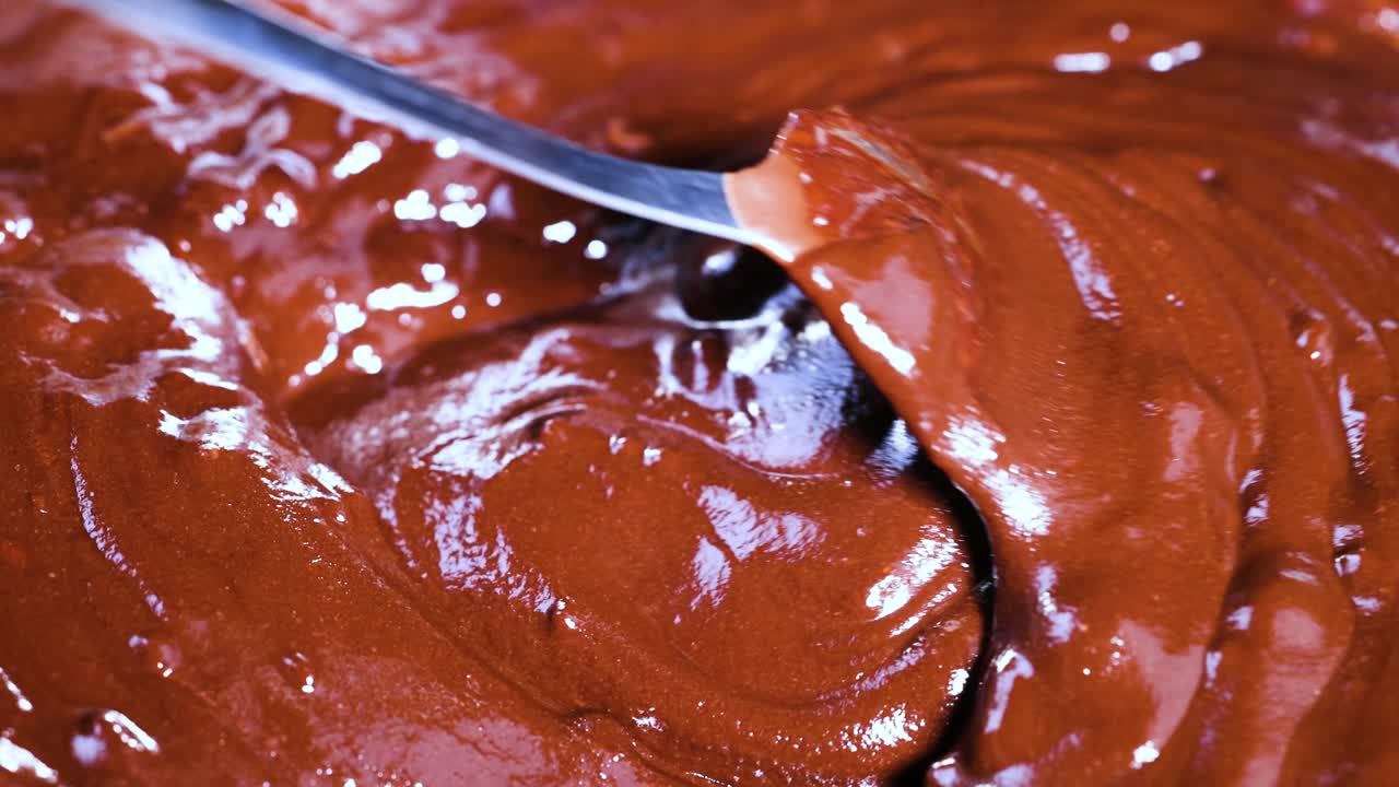 Close-up of spoon stirring chocolate mixture