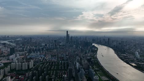 drone aerial view of buildings, cityscape and river in downtown