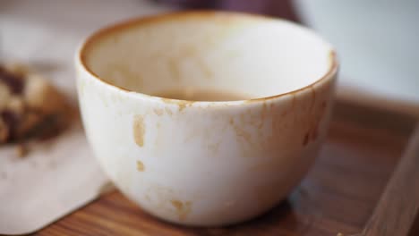 empty coffee cup on a wooden tray