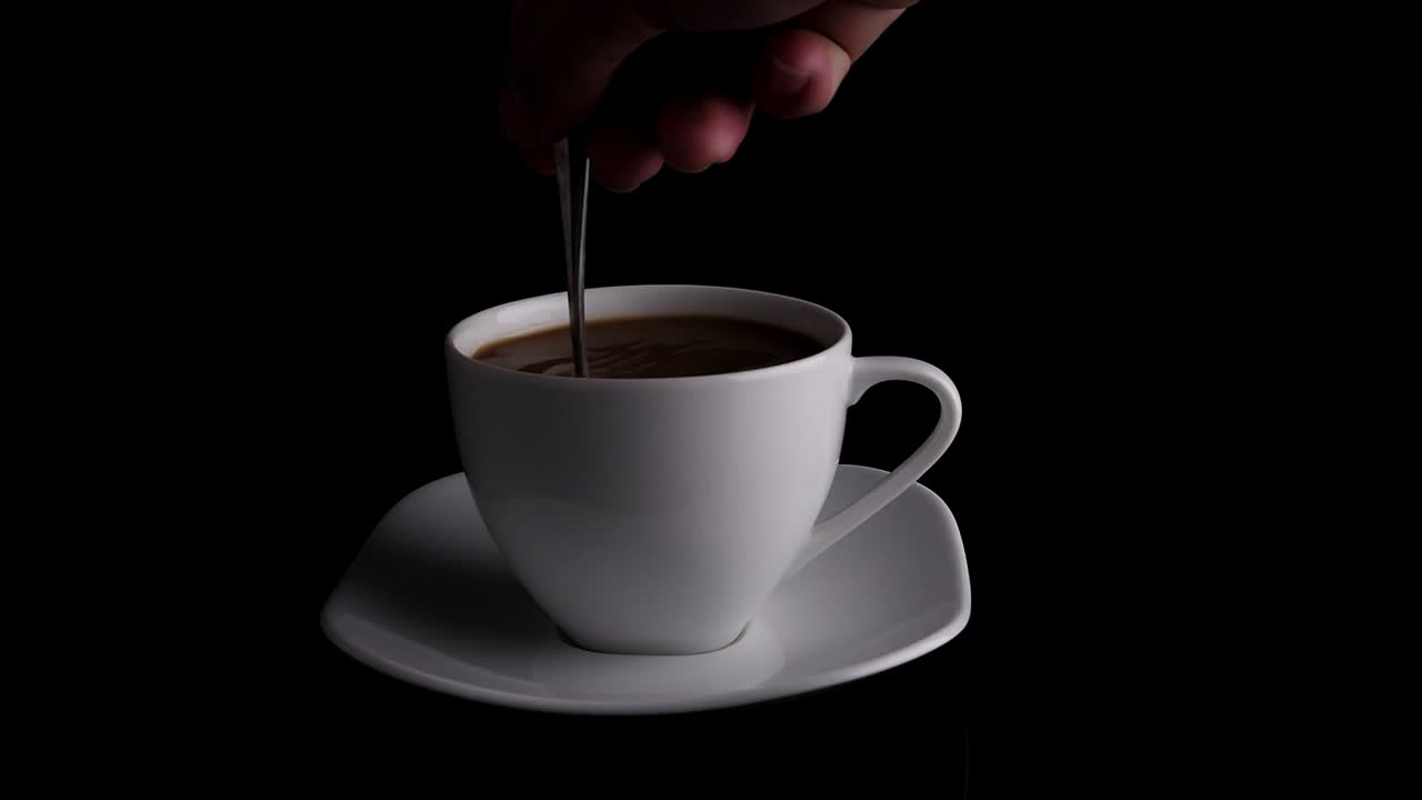 Hand Stirring Coffee With Spoon