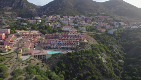 aerial view travelling out to the city of nebida, sardinia, on a sunny day