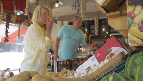 people buying tomatoes in greengrocery