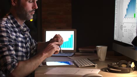 Side-view-of-businessman-working-late-in-office