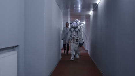 astronauts and scientists in a futuristic corridor