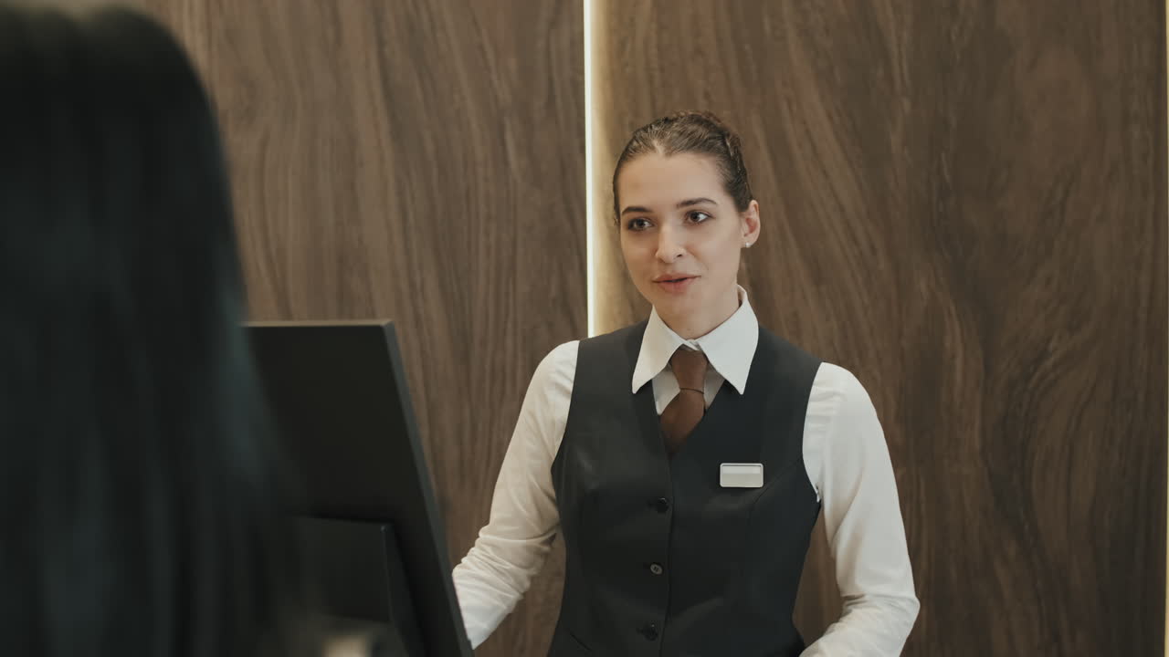Receptionist Talking to Guest during Check-In