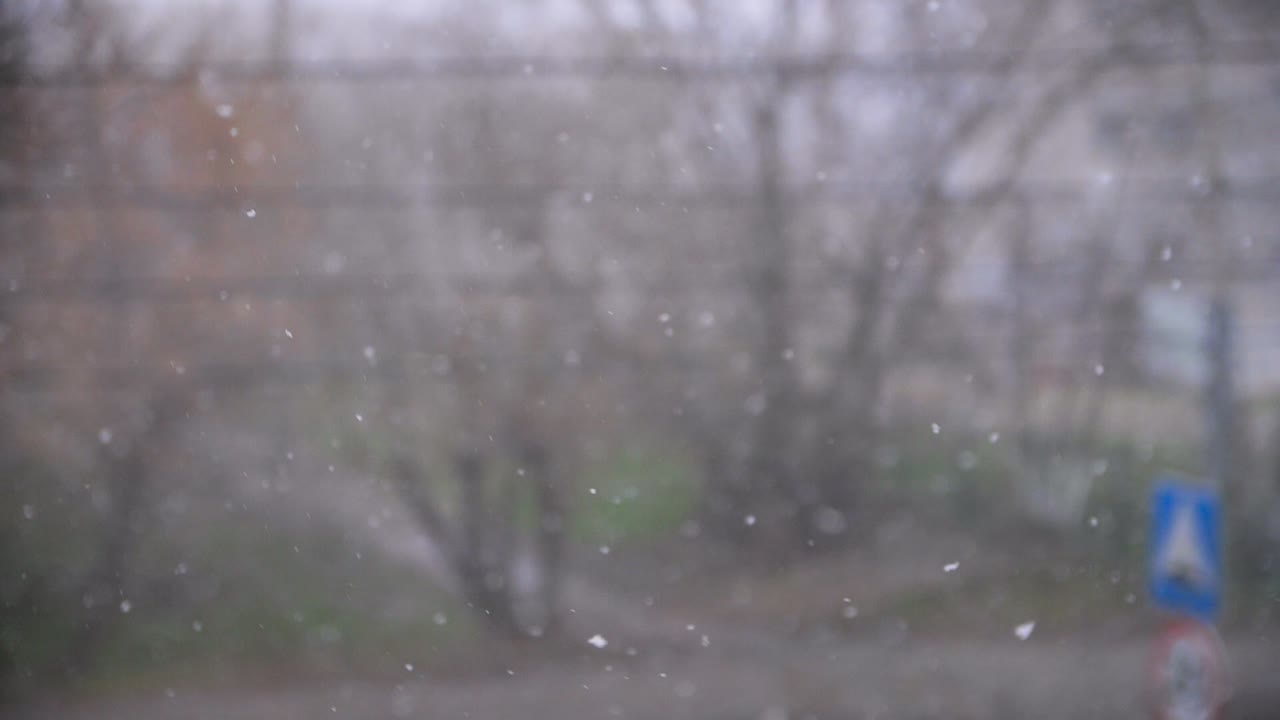 Snow falling outside a window