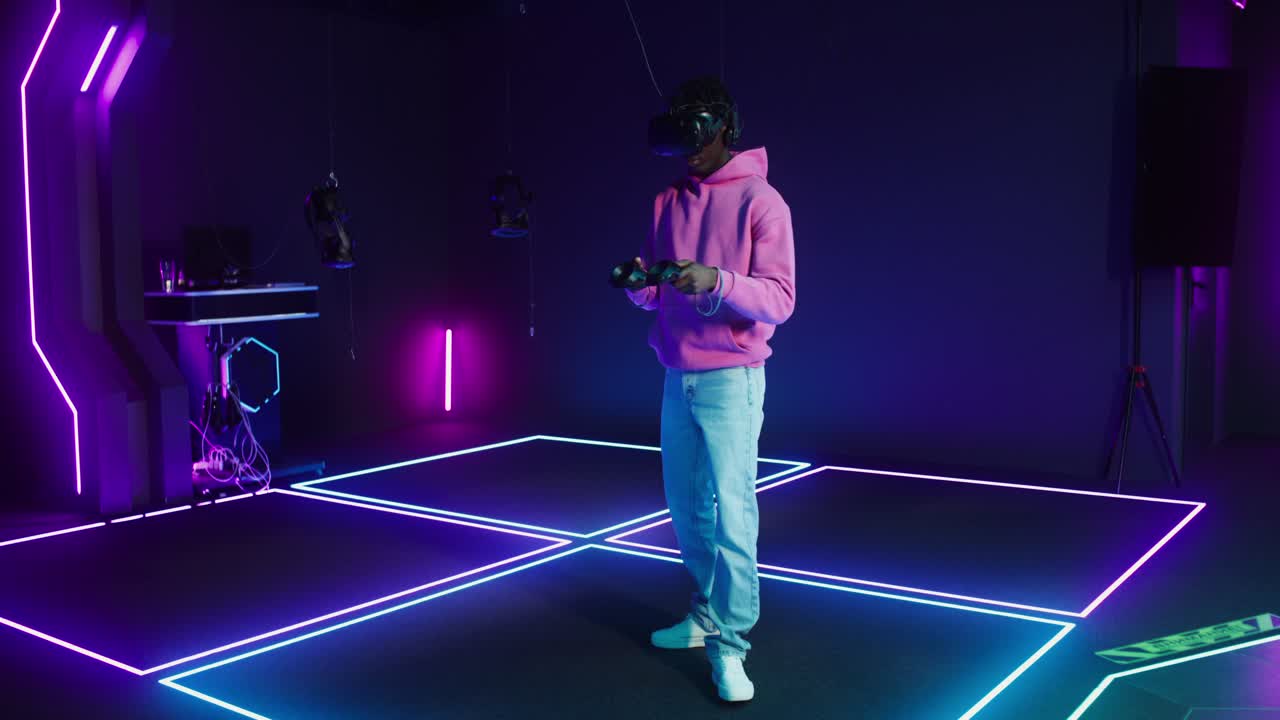 A person using VR in a neon lit room