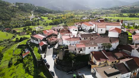 sunlight shines down on castle walls in vinhais, braganza, portugal, aerial orbit