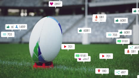 Animación-De-íconos-De-Redes-Sociales-Flotando-Contra-El-Primer-Plano-De-Una-Pelota-De-Rugby-En-Una-Tribuna-Del-Estadio.