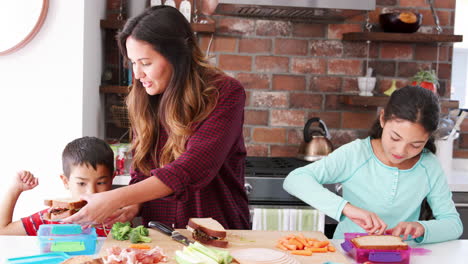 Children-Helping-Mother-To-Make-Sandwiches-For-Packed-Lunch-In-Kitchen