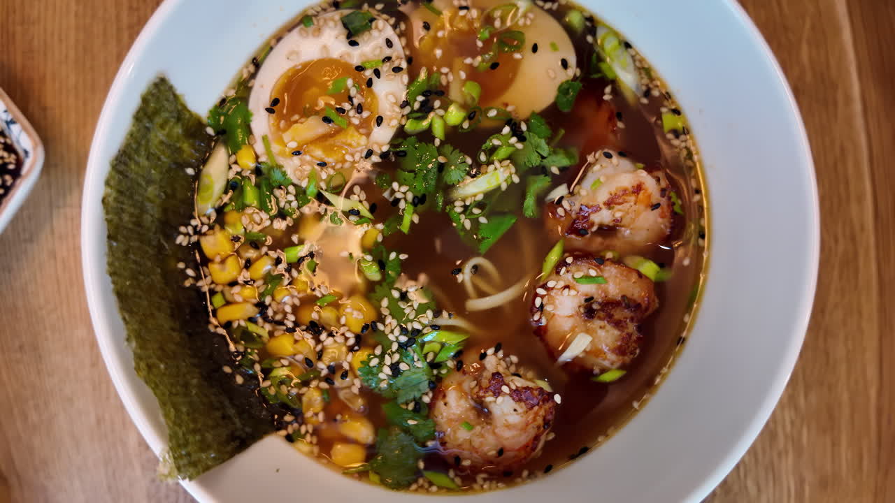 Top view of ramen soup with shrimps and eggs and japanese noodles