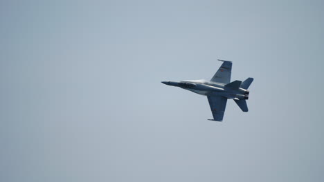 fighter jet in sky captured with tilted angle during high speed directional turn