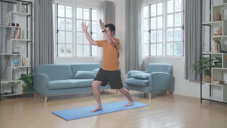 man doing yoga at home