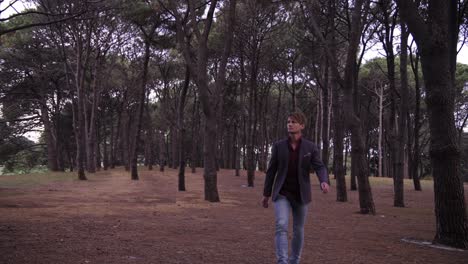 suited casual man  with pine tree forest surrounding him