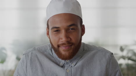 portrait young confident muslim businessman smiling enjoying successful career mixed race entrepreneur wearing kufi hat in office slow motion