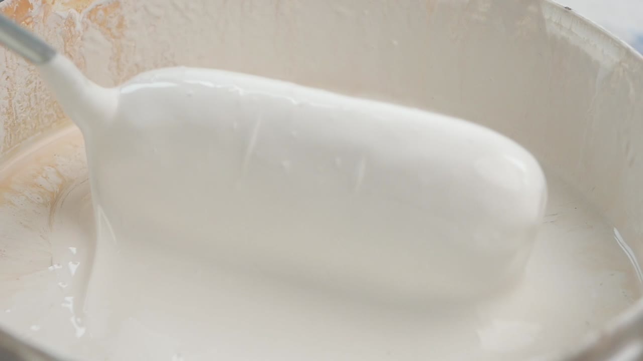 Mixing White Paint in a Bucket