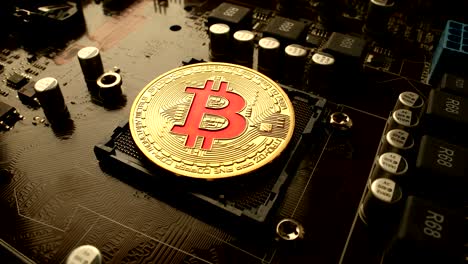 gold bit coin btc coins on the motherboard. bitcoin is a worldwide cryptocurrency and digital payment system called the first decentralized digital currency.