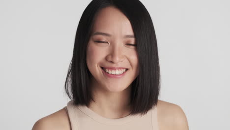 asian woman smiling to the camera.