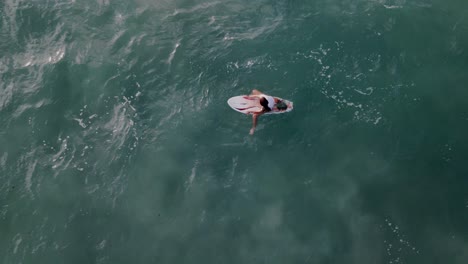 netanya, israel, the surfer rides on the wave and perform tricks on a wave at sunset