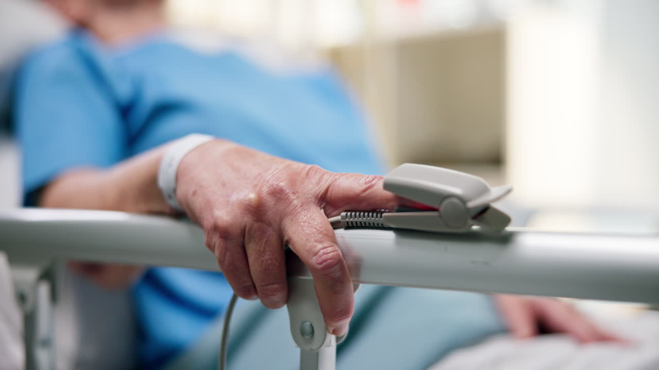 Patient in Hospital Bed with Pulse Oximeter