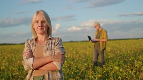 female farmer and male technician in soybean field