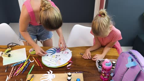 mother and daughter making a craft project together