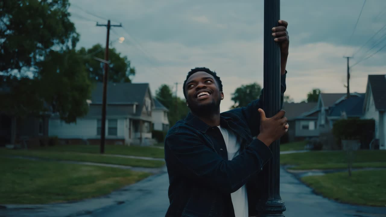 Man smiling on a street at night