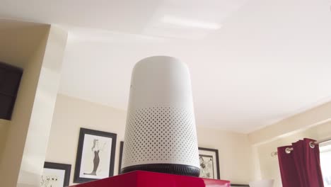 an air purifier sitting in a living room cleaning smoke, dust and pollen etc