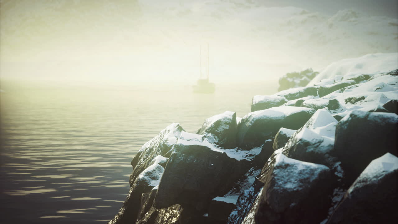 Stunning coastal view with rocks and a boat near the shore at dawn