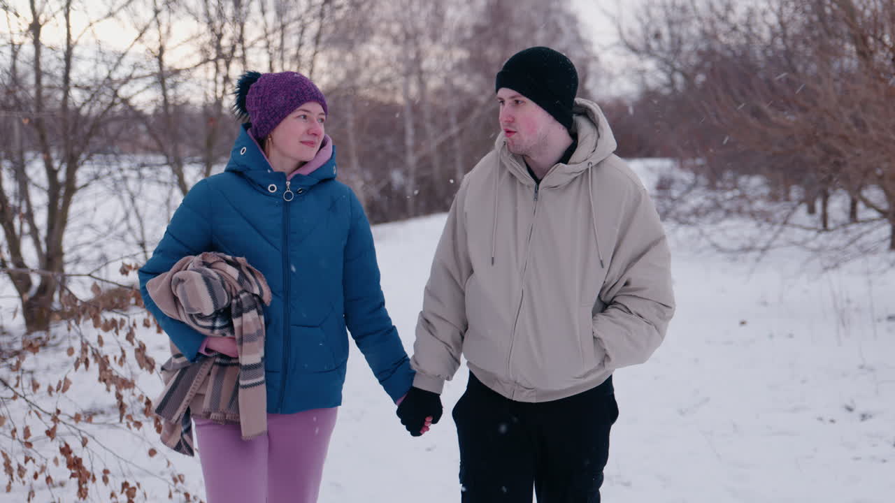 Couple Walking in Snowy Park