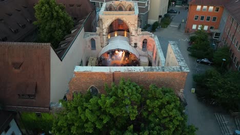 4k aerial drone video of band performing in a roof-less church in nurnberg, germany