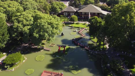 aerial shot of people enjoying japanese garden park in buenos aires at sunset time, argentina